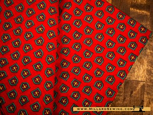 Remnant (Cotton) Red Background with Coat of Arms Shield (5 yds)