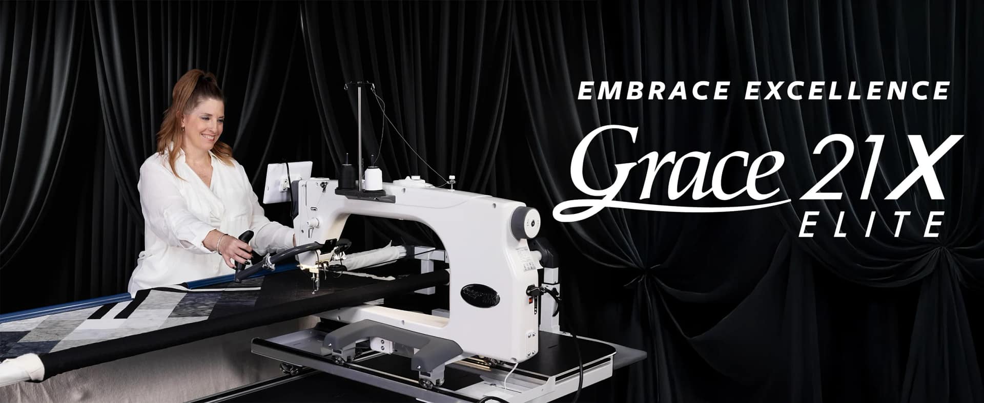 Grace 21X Elite longarm quilting machine in use on a quilting frame